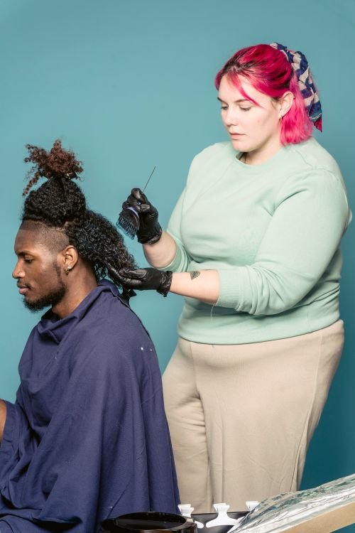 Hairdresser styling a client’s hair — stock photograph